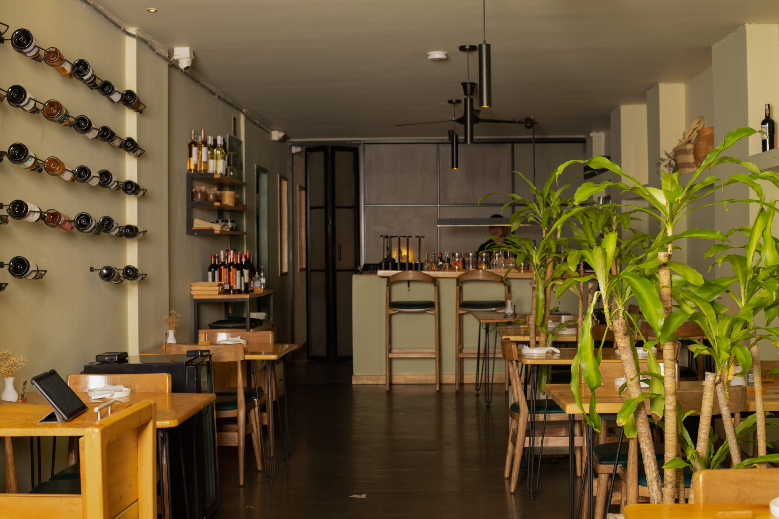 Main dining room of Idílico Restaurant in Medellín, set for à la carte service with elegant tables and modern design.